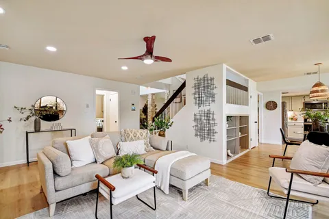 a living room with furniture and wooden floor