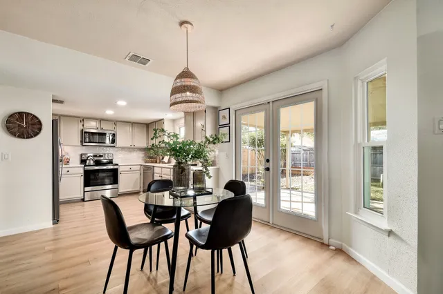 a view of a dining room with furniture window and wooden floor