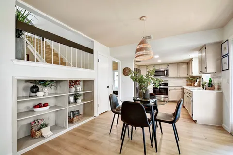 a view of a dining room with furniture and a kitchen