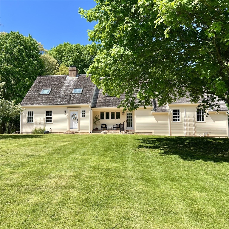 a aerial view of a house next to a big yard