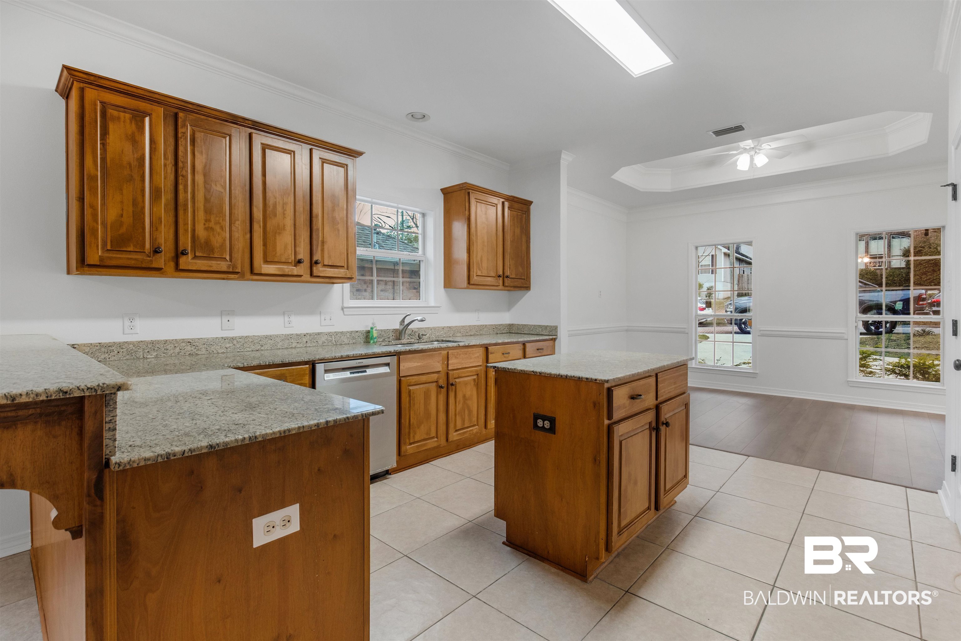 1007 Linlen Avenue Mobile, AL 36609 - Photo 6 of 21 Kitchen with light hardwood / wood-style floors, sink, ornamental molding, a center island, and dishwasher