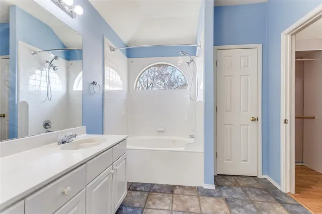 an empty room with a fireplace wooden floor and windows