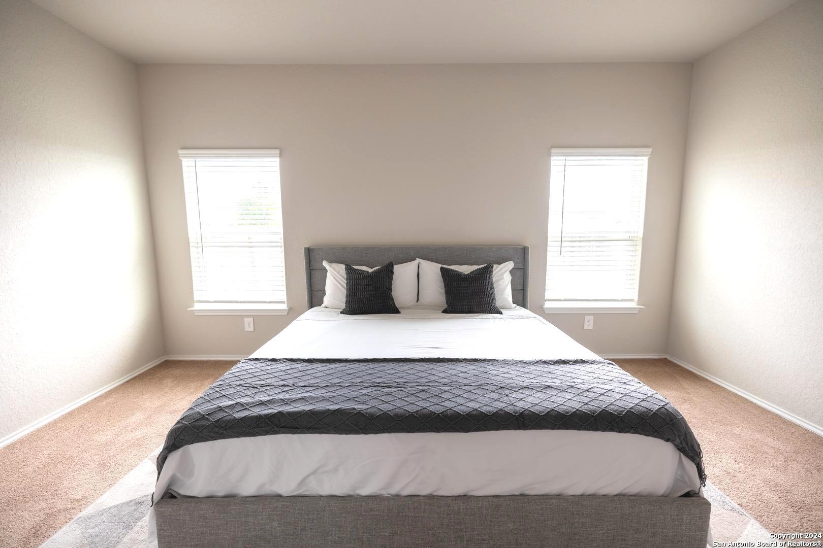 3431 Andromeda Way Converse, TX 78109 - Photo 12 of 24 a bedroom with a bed and a window