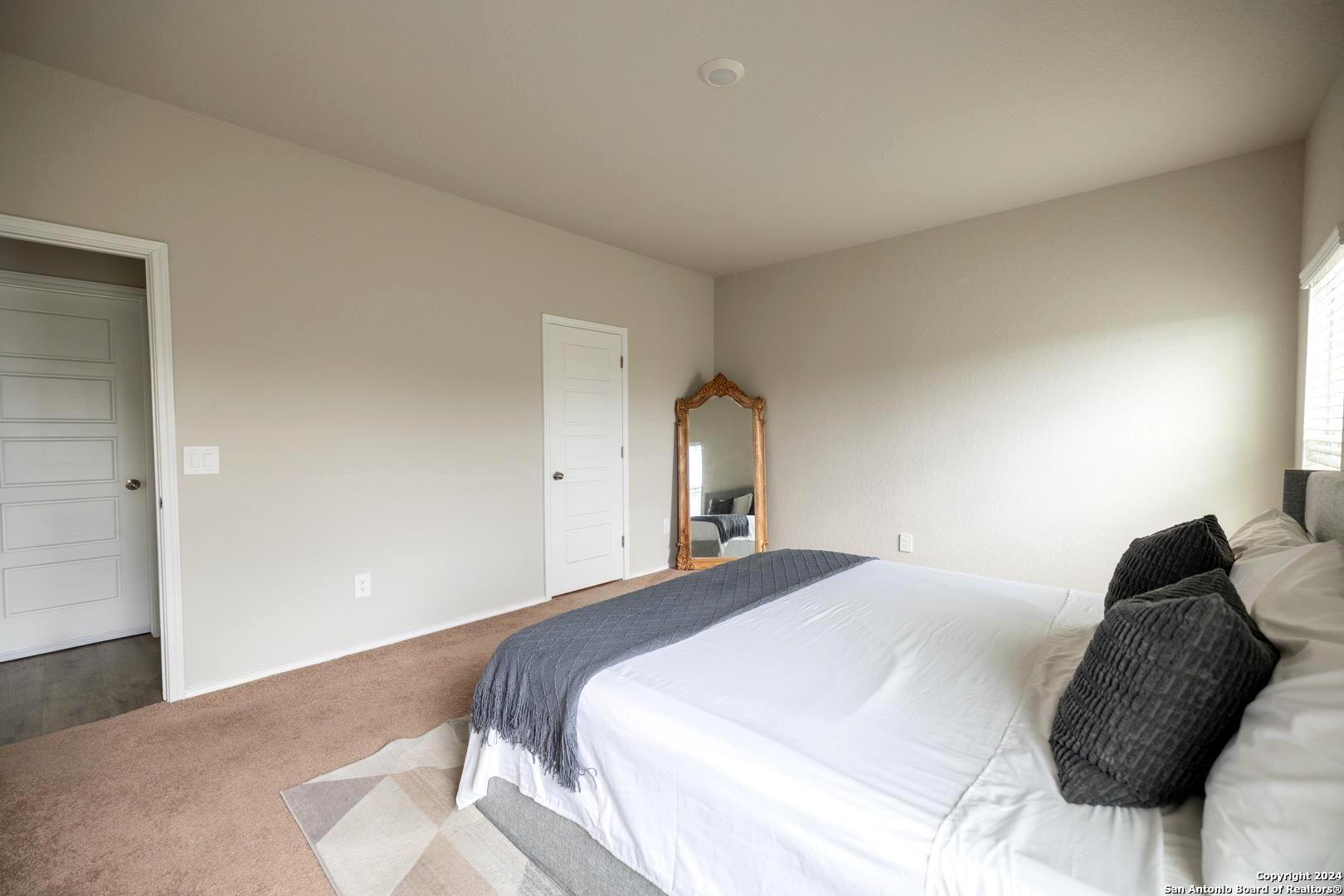 3431 Andromeda Way Converse, TX 78109 - Photo 13 of 24 a bedroom with a bed and a chair