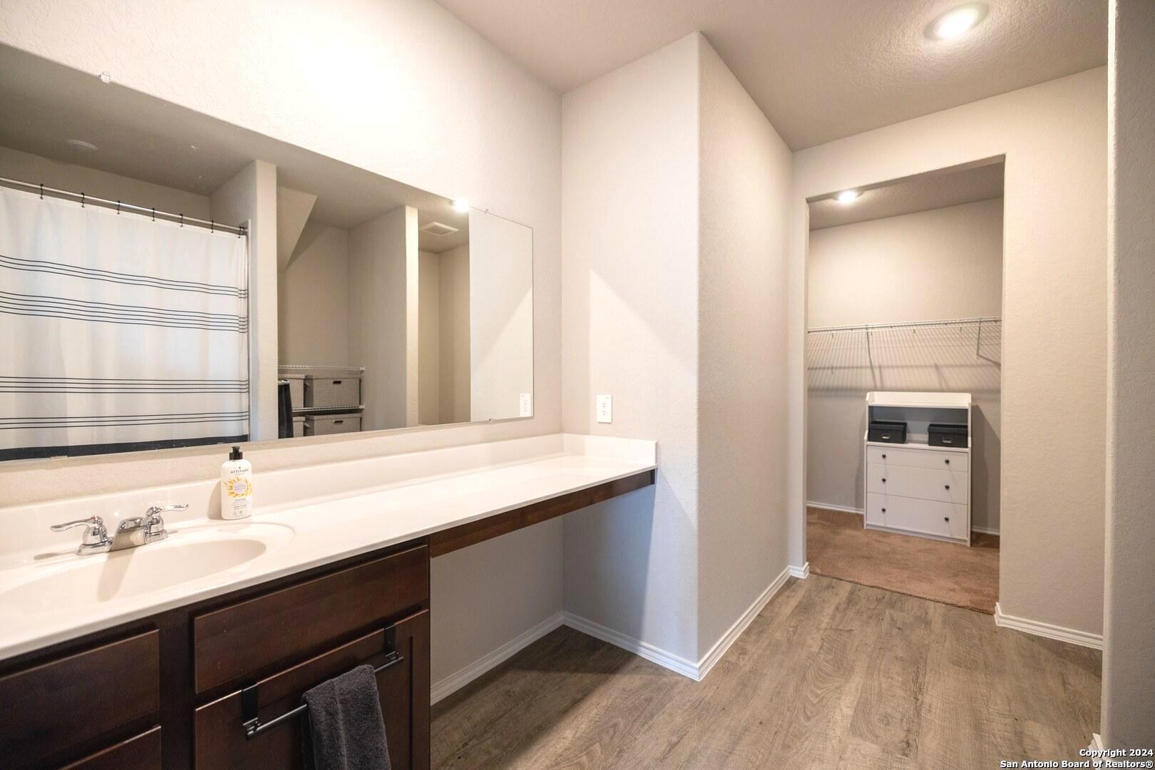 3431 Andromeda Way Converse, TX 78109 - Photo 14 of 24 a bathroom with a sink and a mirror