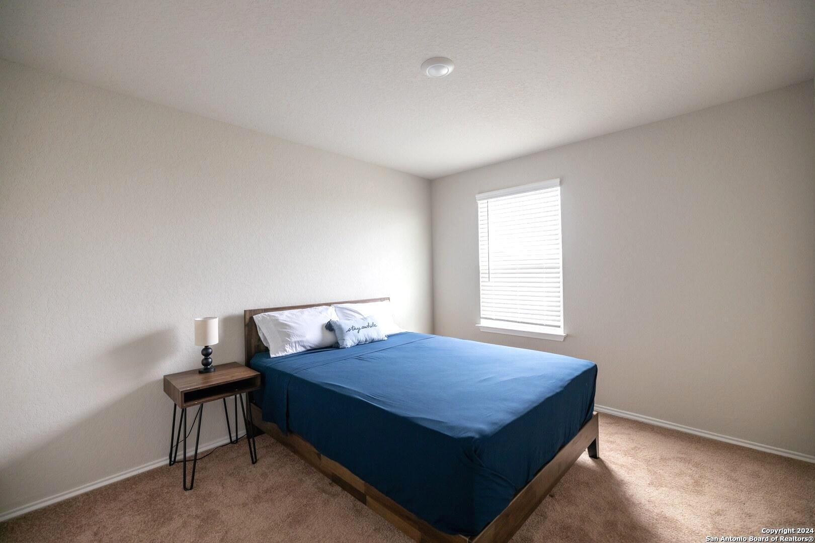 3431 Andromeda Way Converse, TX 78109 - Photo 17 of 24 a bedroom with a bed and a window