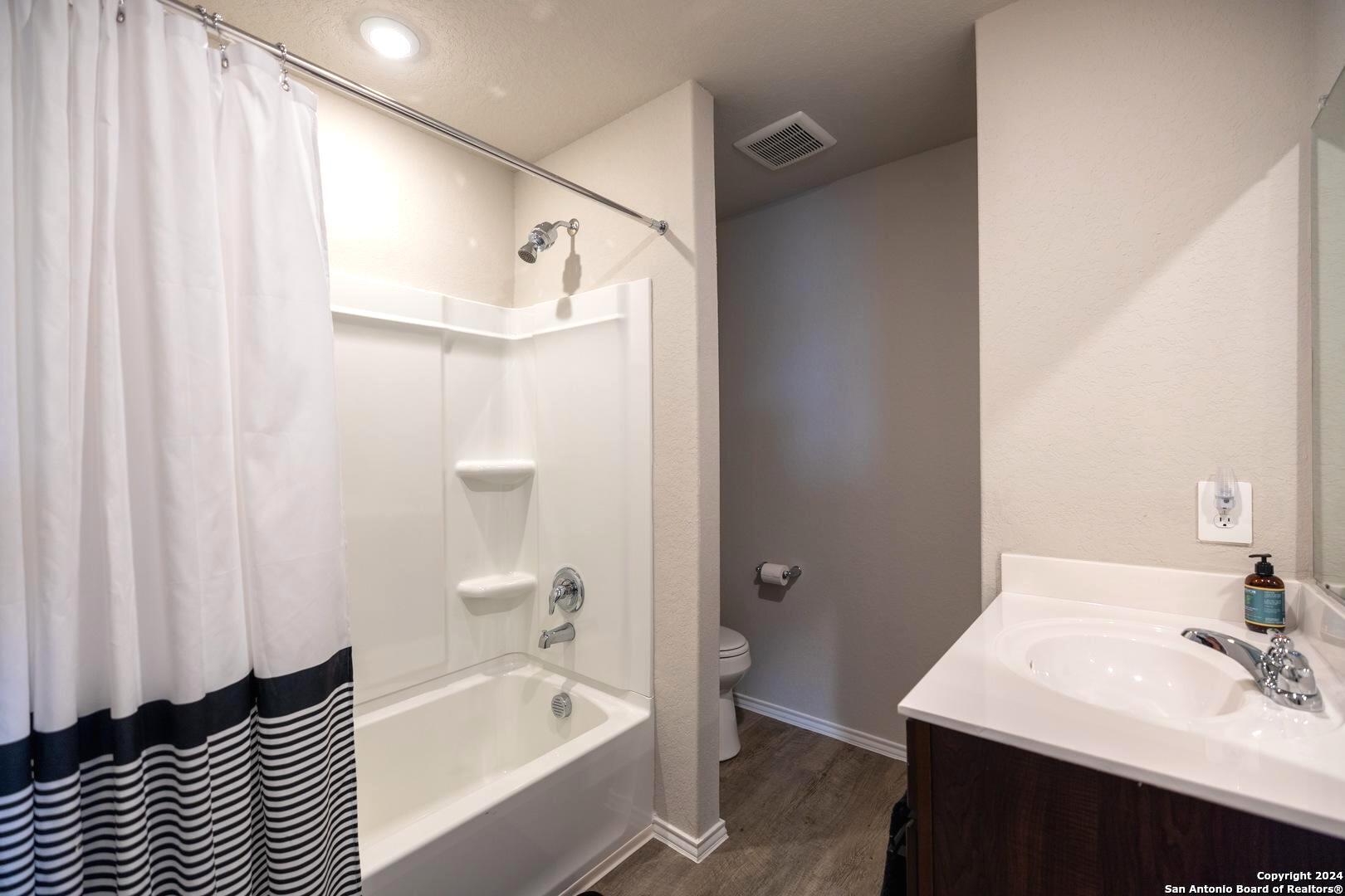 3431 Andromeda Way Converse, TX 78109 - Photo 19 of 24 a bathroom with a sink a bathtub and a mirror