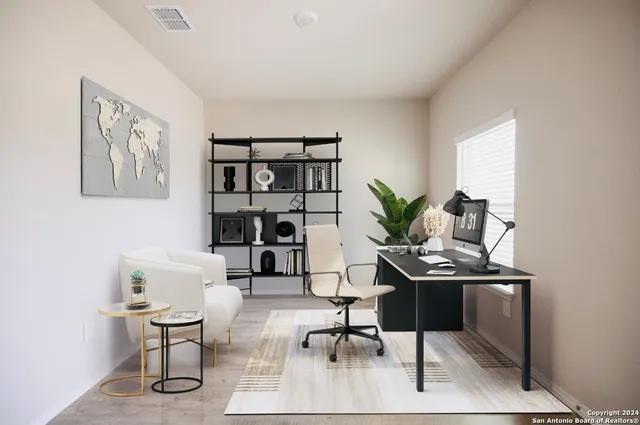a view of a workspace with furniture and wooden floor