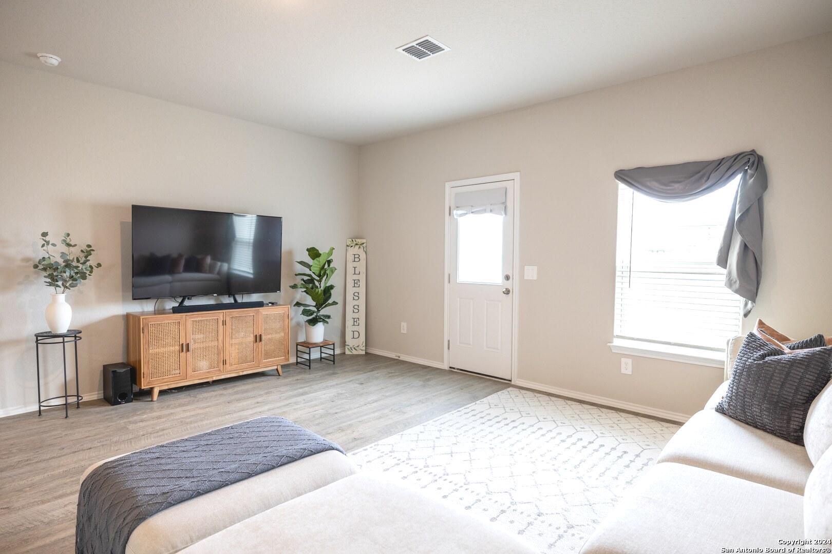 3431 Andromeda Way Converse, TX 78109 - Photo 5 of 24 a living room with furniture and a flat screen tv
