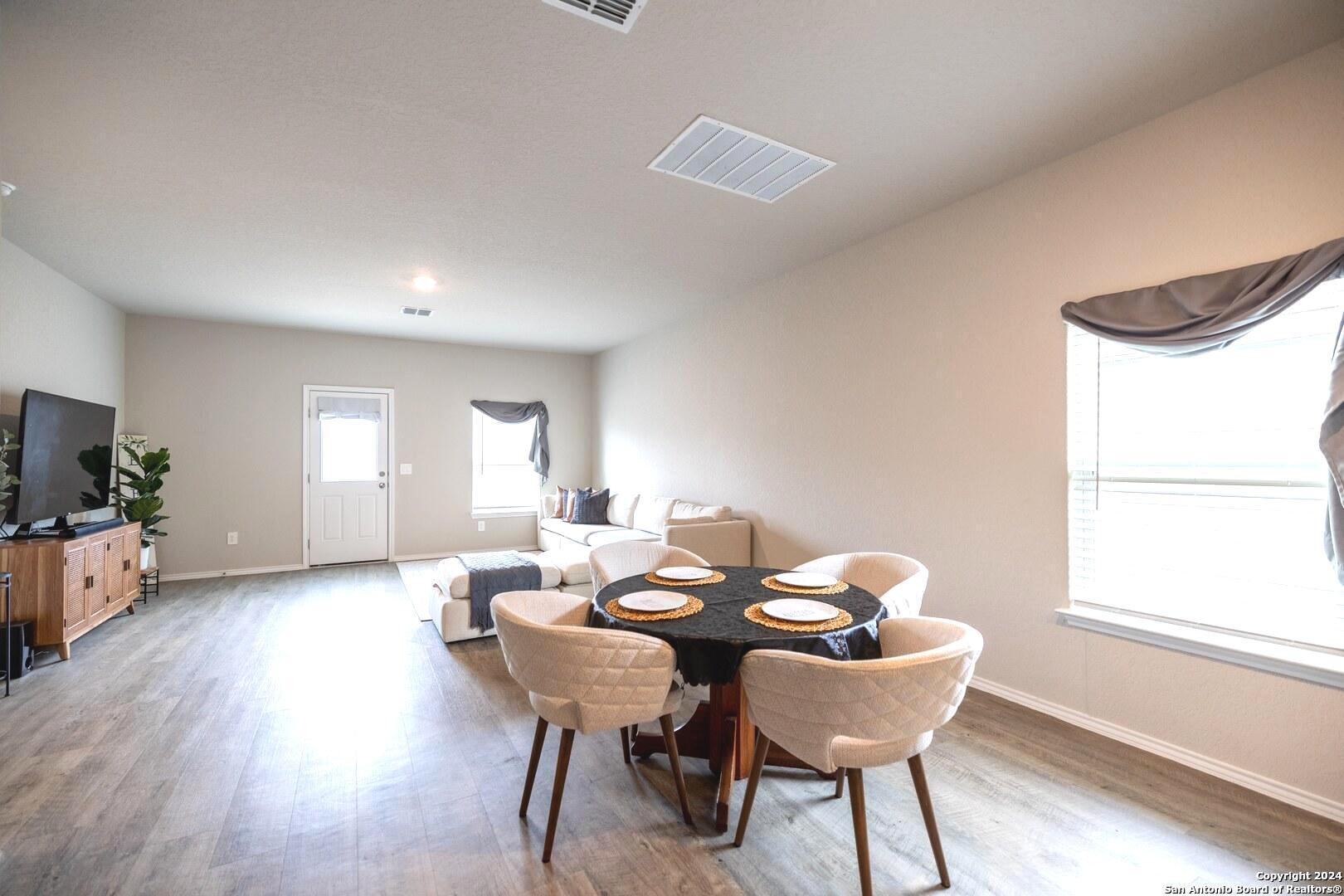 3431 Andromeda Way Converse, TX 78109 - Photo 10 of 24 a view of a dining room with furniture and wooden floor