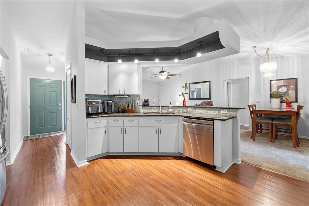 11244 Redgate Street Spring Hill, FL 34609 - Photo 13 of 50 a large kitchen with a large counter top space a sink stainless steel appliances and cabinets
