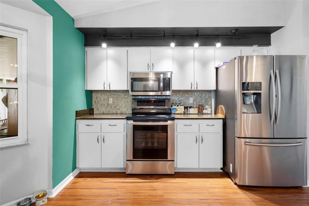 11244 Redgate Street Spring Hill, FL 34609 - Photo 15 of 50 a kitchen with a refrigerator and a stove