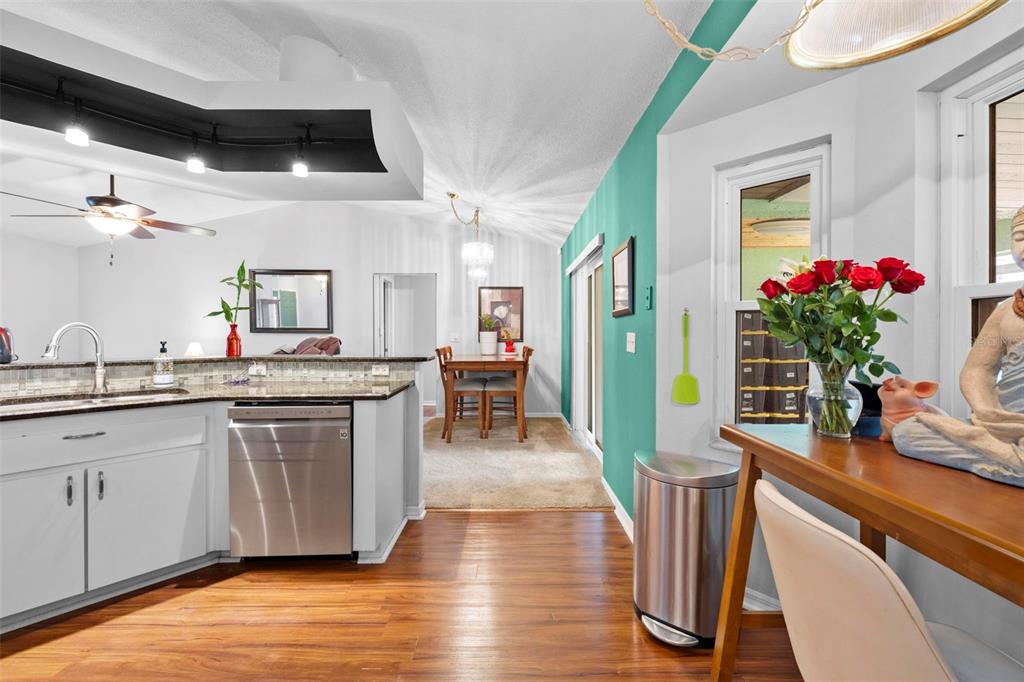 11244 Redgate Street Spring Hill, FL 34609 - Photo 16 of 50 a view interior of a house and dining room with wooden floor