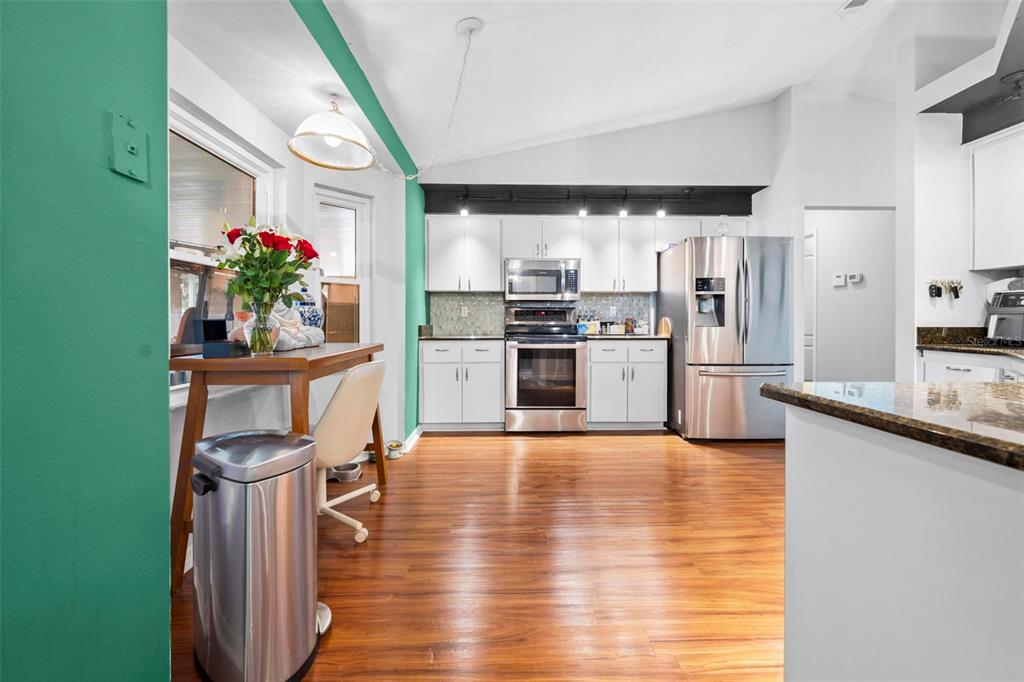 11244 Redgate Street Spring Hill, FL 34609 - Photo 18 of 50 a kitchen with granite countertop stainless steel appliances and wooden cabinets