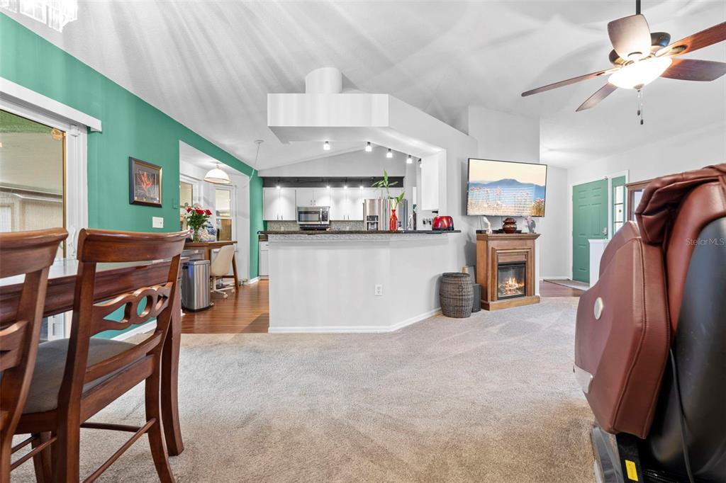 11244 Redgate Street Spring Hill, FL 34609 - Photo 22 of 50 a kitchen with stainless steel appliances refrigerator dining table and chairs