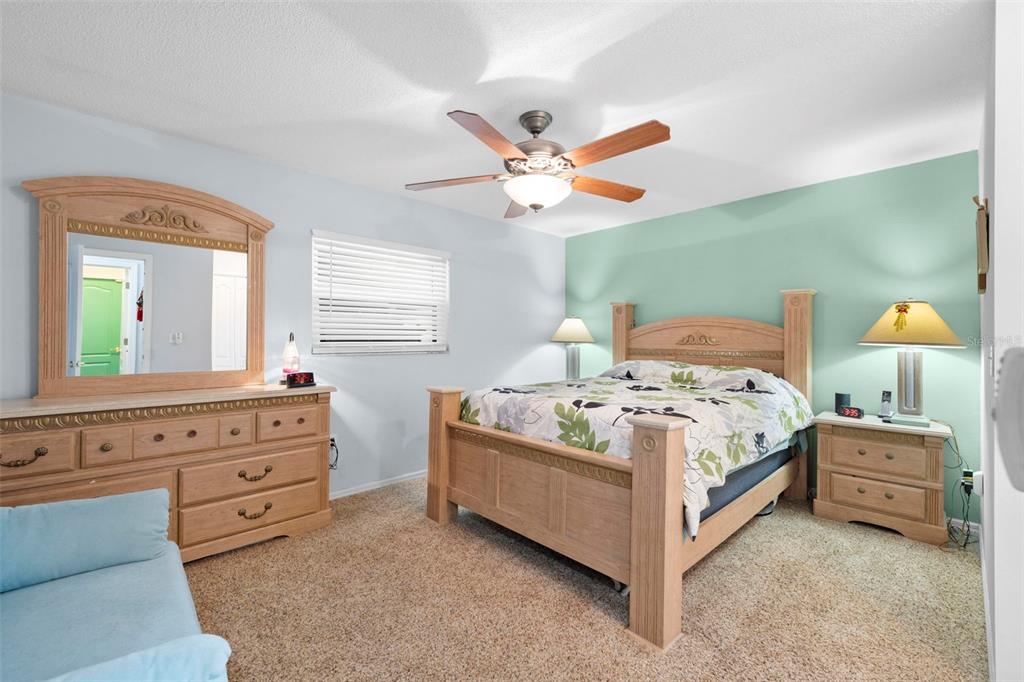 11244 Redgate Street Spring Hill, FL 34609 - Photo 38 of 50 a bedroom with a bed and a window