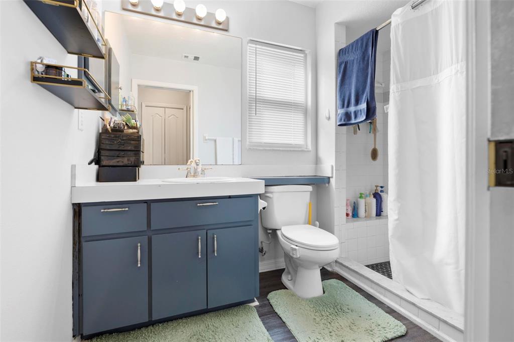 11244 Redgate Street Spring Hill, FL 34609 - Photo 40 of 50 a bathroom with a sink toilet and a mirror