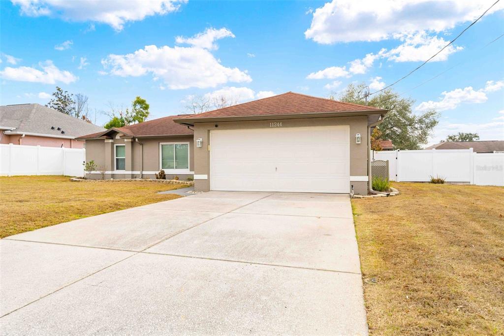 11244 Redgate Street Spring Hill, FL 34609 - Photo 41 of 50 a front view of house with yard