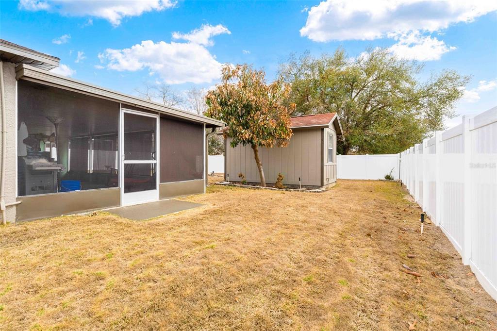 11244 Redgate Street Spring Hill, FL 34609 - Photo 45 of 50 a view of a house with a yard