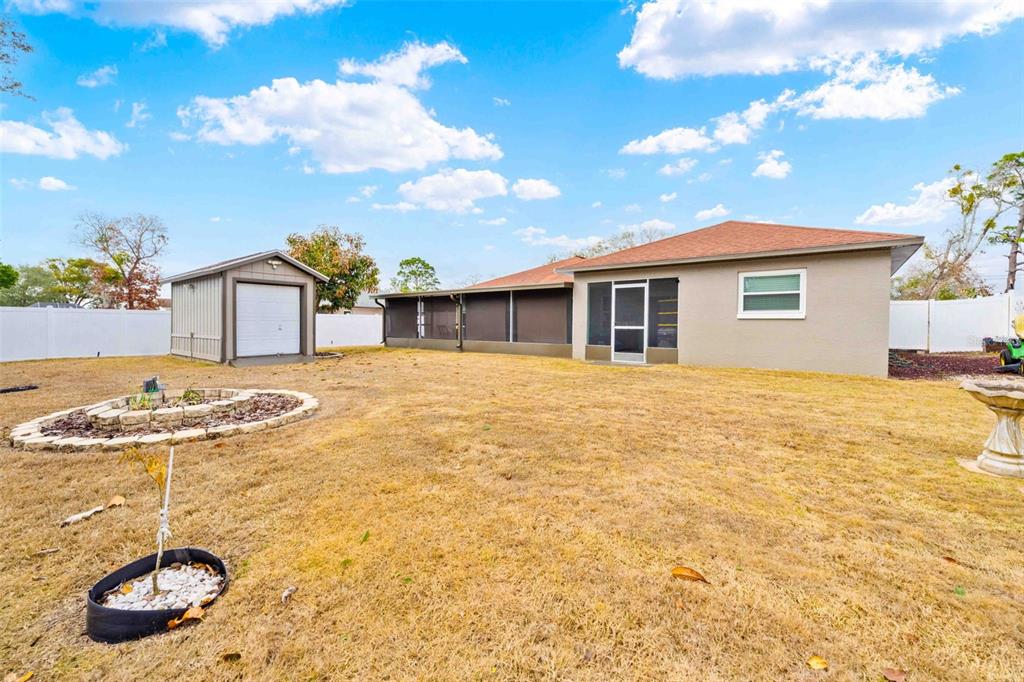11244 Redgate Street Spring Hill, FL 34609 - Photo 47 of 50 a view of a house with backyard and sitting area