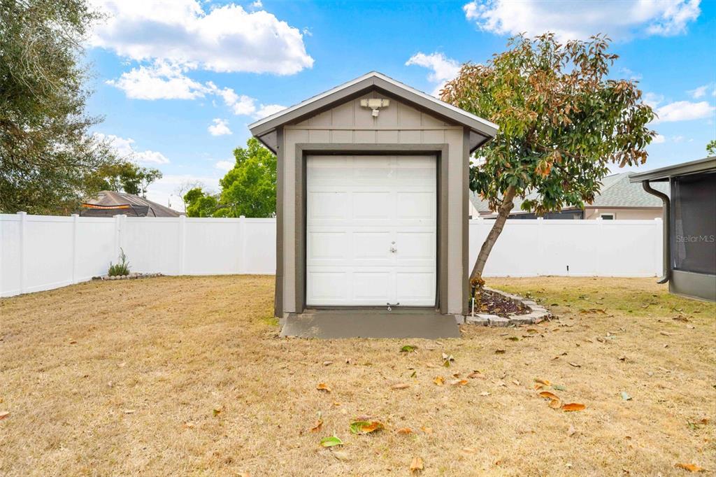 11244 Redgate Street Spring Hill, FL 34609 - Photo 49 of 50 a view of wooden fence in front of a house