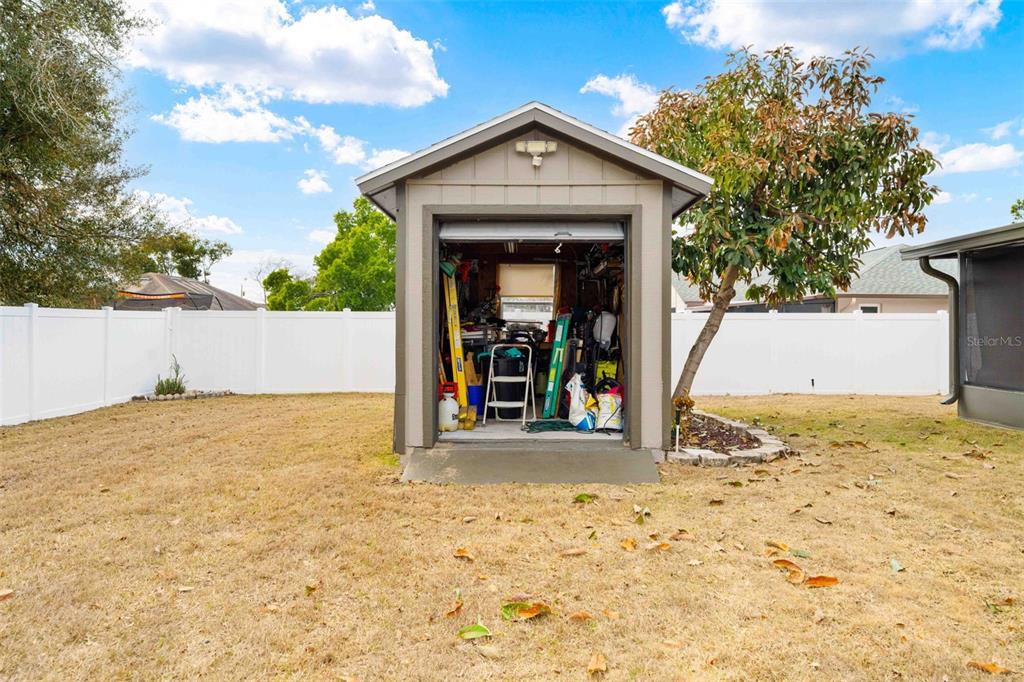 11244 Redgate Street Spring Hill, FL 34609 - Photo 50 of 50 a view of a wooden house with a yard