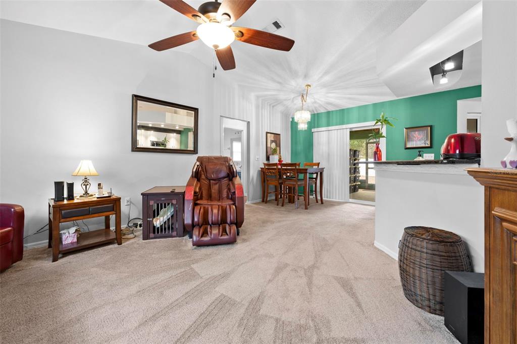 11244 Redgate Street Spring Hill, FL 34609 - Photo 7 of 50 a living room with furniture and a flat screen tv