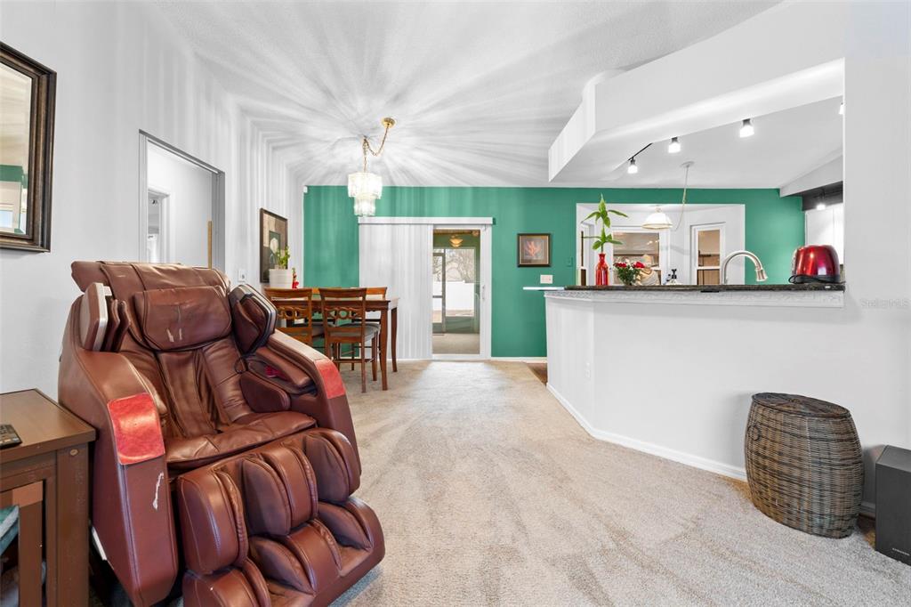11244 Redgate Street Spring Hill, FL 34609 - Photo 8 of 50 a living room with furniture and a wooden floor