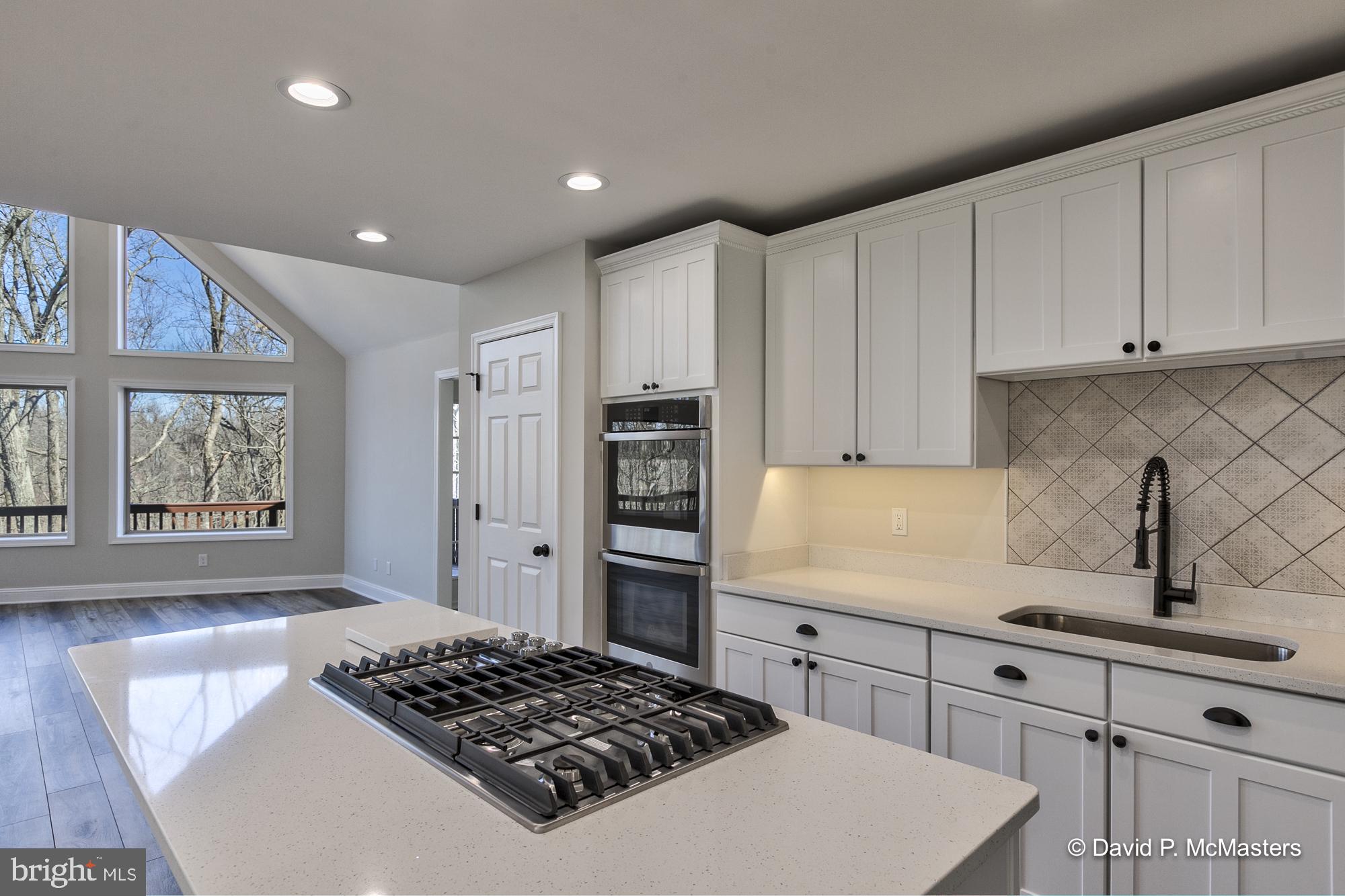 760 High Knob Road Front Royal, VA 22630 - Photo 14 of 63 a kitchen with stainless steel appliances granite countertop a sink stove and refrigerator