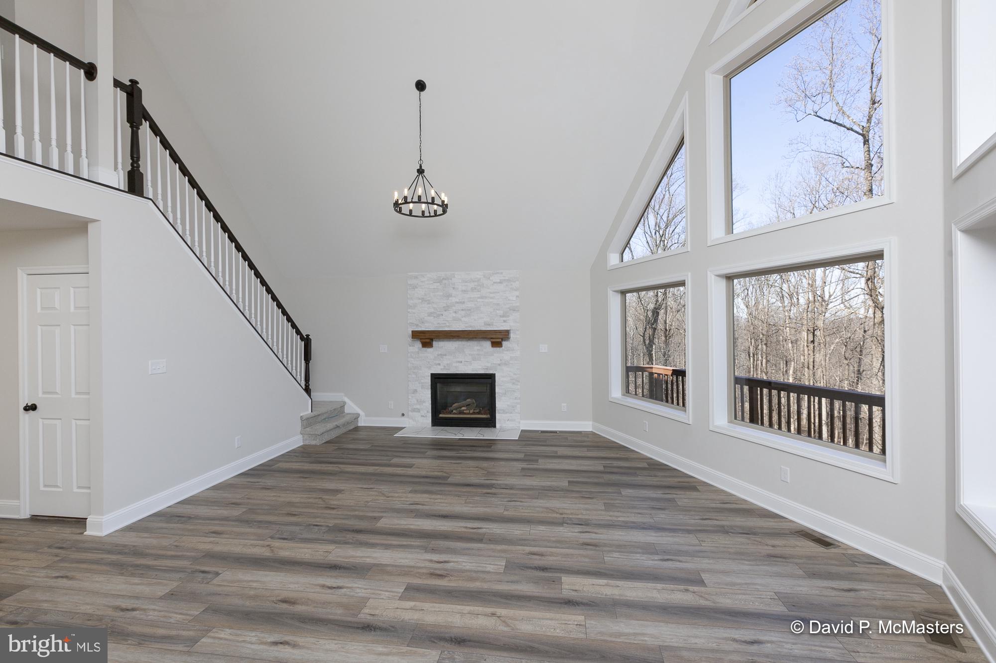 760 High Knob Road Front Royal, VA 22630 - Photo 7 of 63 a view of empty room with wooden floor and fan