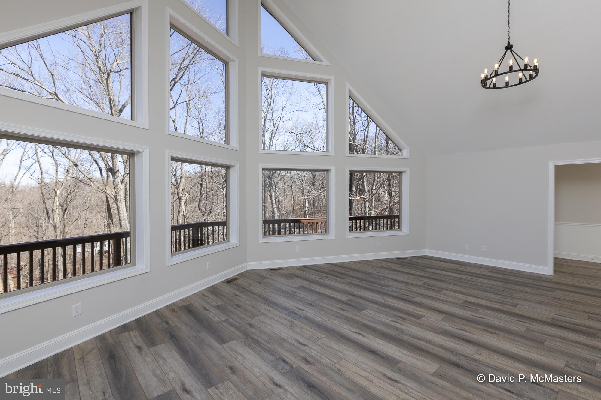 760 High Knob Road Front Royal, VA 22630 - Photo 8 of 63 a view of an empty room with wooden floor and windows