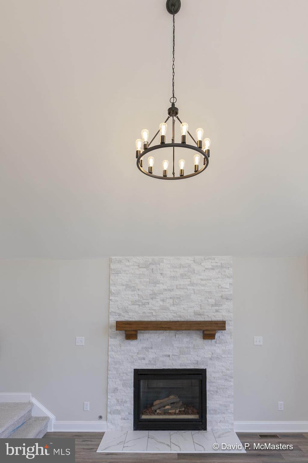 760 High Knob Road Front Royal, VA 22630 - Photo 9 of 63 a view of a hallway with a chandelier fan and fireplace