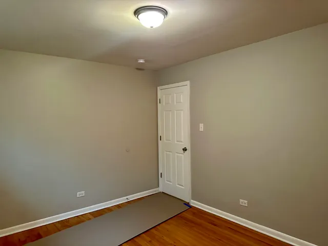 an empty room with wooden floor