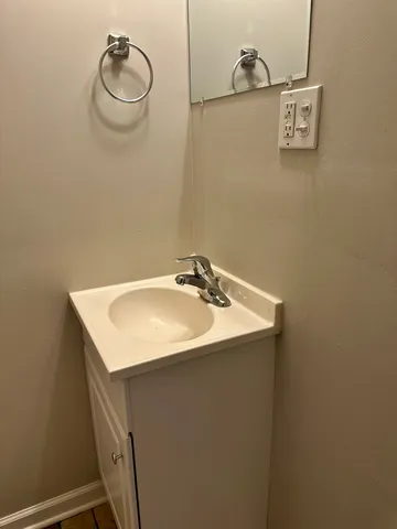 a bathroom with a sink a toilet and a mirror