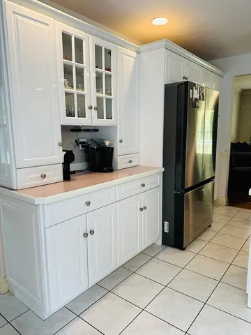 a kitchen with stainless steel appliances a refrigerator sink and cabinets