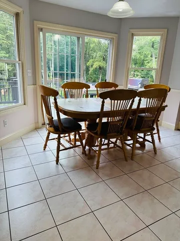 a view of a dining room and livingroom with furniture