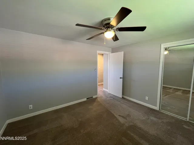 an empty room with closet and wooden floor
