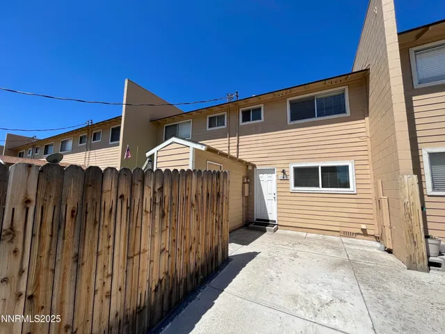 a view of a house with a wooden fence