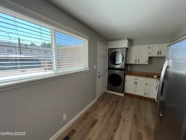 a kitchen with a refrigerator and window