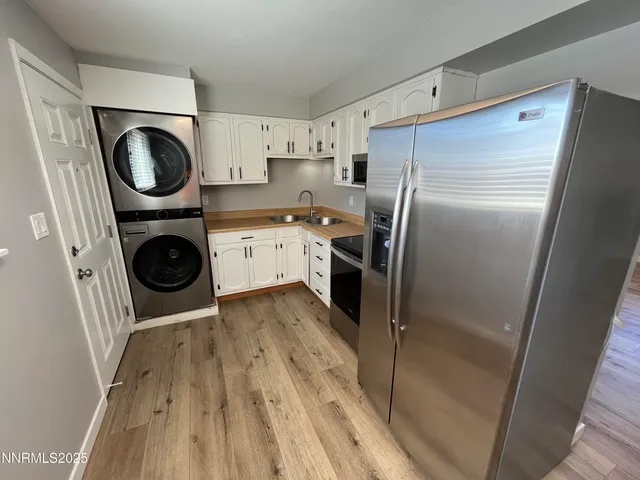 a kitchen with a refrigerator and washer dryer