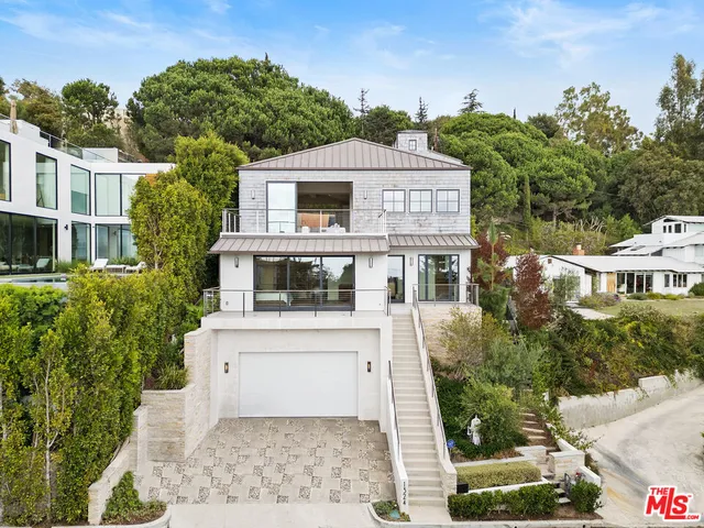 a aerial view of a house with a yard and potted plants