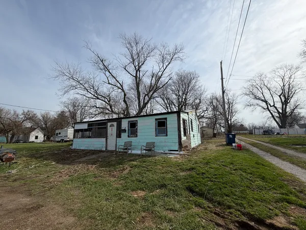 a view of a backyard with a white house