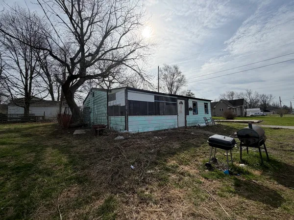 a backyard of a house with table and chairs