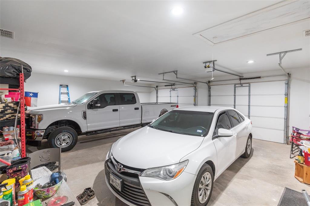 760 Wimberly Road Merkel, TX 79536 - Photo 31 of 35 Spacious garage featuring two overhead doors, recessed lighting, and a finished ceiling