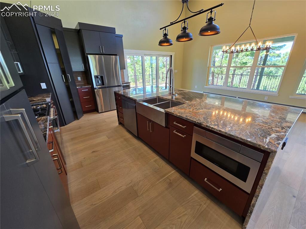 33036 Meadow Ridge Lane Trinidad, CO 81082 - Photo 24 of 50 Kitchen featuring pendant lighting, light hardwood / wood-style flooring, stainless steel appliances, an island with sink, and sink