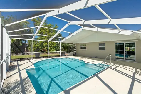 a view of an house with backyard and porch