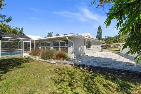 a view of house with backyard and swimming pool