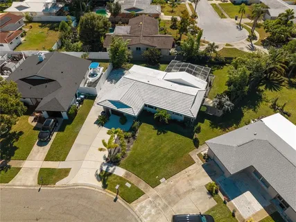 an aerial view of a house with a yard basket ball court and outdoor seating