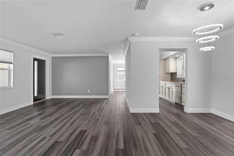 a view of wooden floor and windows in a room