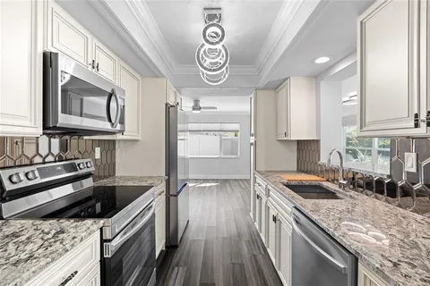 a kitchen with stainless steel appliances granite countertop a stove and a sink